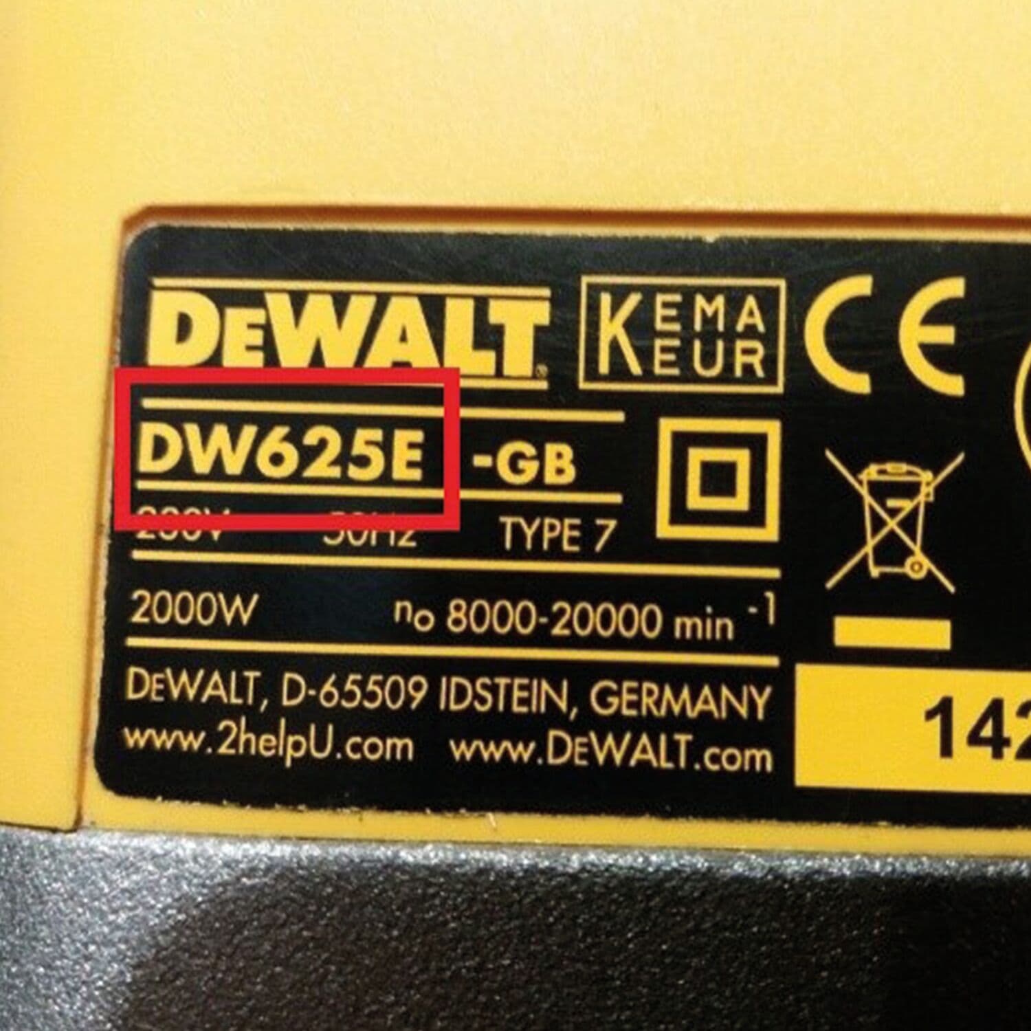 Close-up of a DEWALT product label showing model number DW625E inside a red box. The label includes technical specifications, certification marks, and the DEWALT logo.