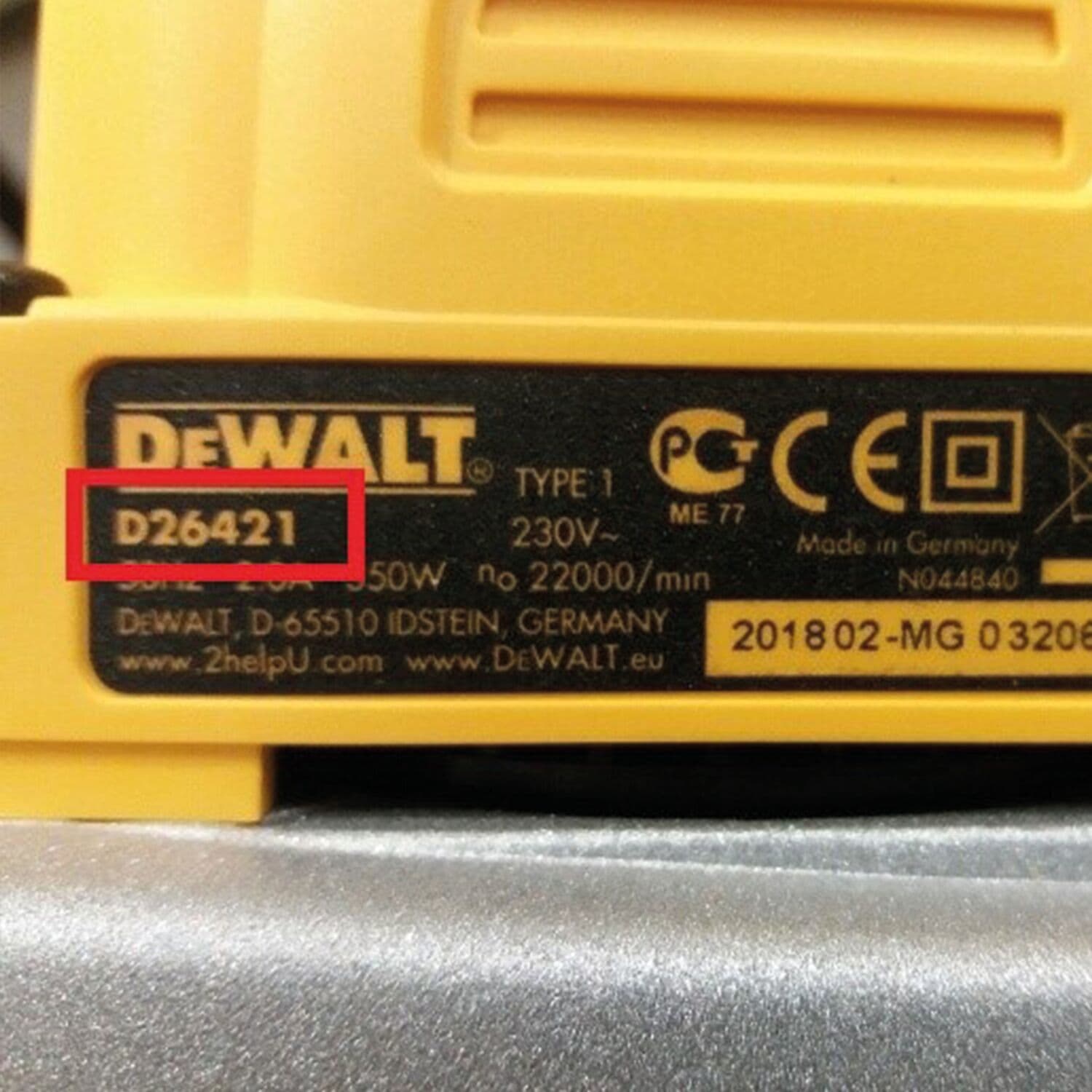 Close-up of a DEWALT power tool label, with the model number D26421 highlighted in red. The label includes specifications such as voltage, wattage, and certification marks, as well as manufacturing information from Germany.
